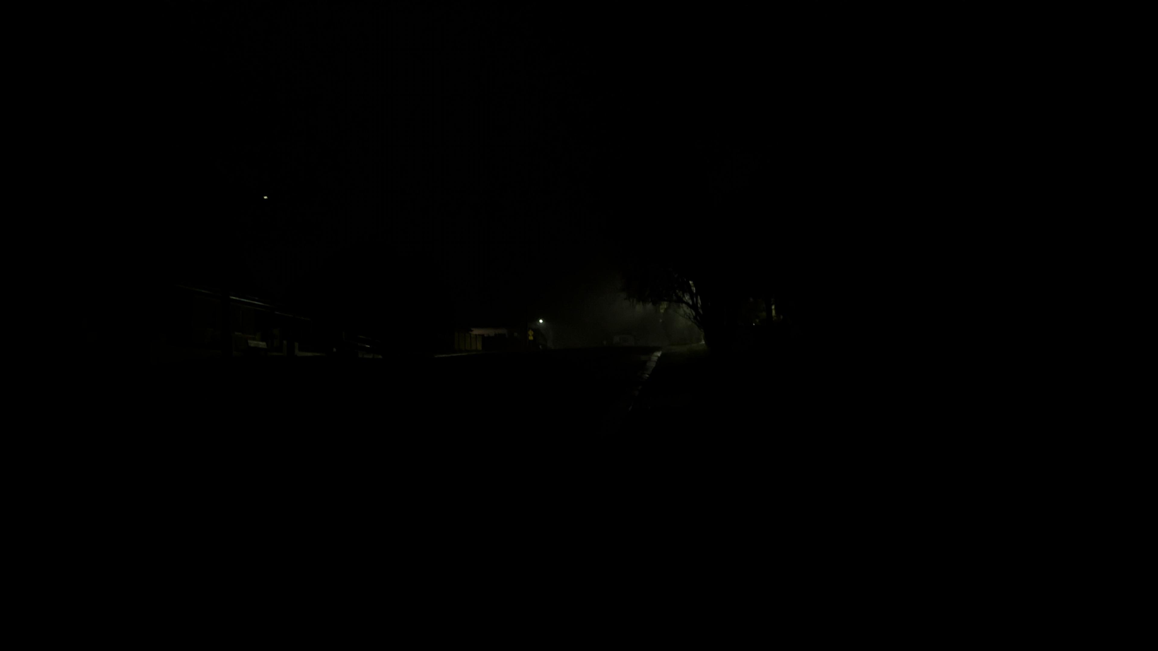 There is some light in the darkness of this photo. What it reveals is unclear.