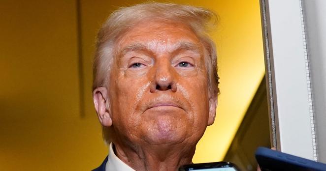 U.S. President Donald Trump looks on as he addresses the media on board Air Force One on the way to West Palm Beach, Florida, U.S., April 13, 2025. REUTERS/Nathan Howard