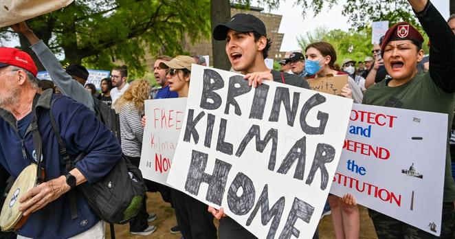 Protestors hold signs saying "Bring Kilmar Home" during a Free Kilmar Abrego and Hands Off protest.
