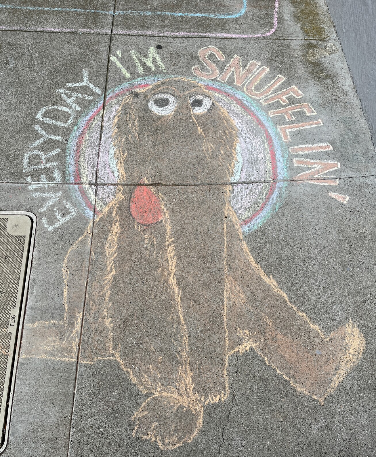Chalk drawing of Snuffleupagus from Sesame Street haloed with the words “Everyday I’m Snuffling” 