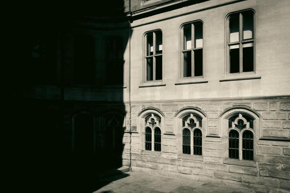 Building exterior with  a part in heavy shadows.