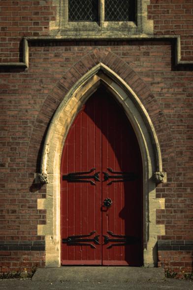 Red door of a chapel.