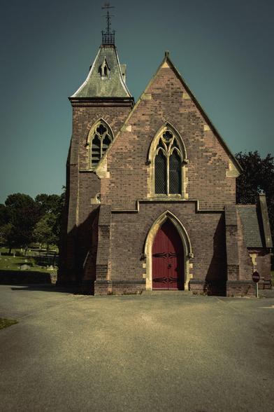 Cemetery chapel with red door in neo-gothic style.