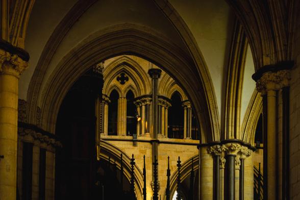 Interior of a gothic cathedral showing arches and windows.