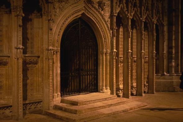 Inside a gothic cathedral: arched gate in front of the passage leading to the choir.