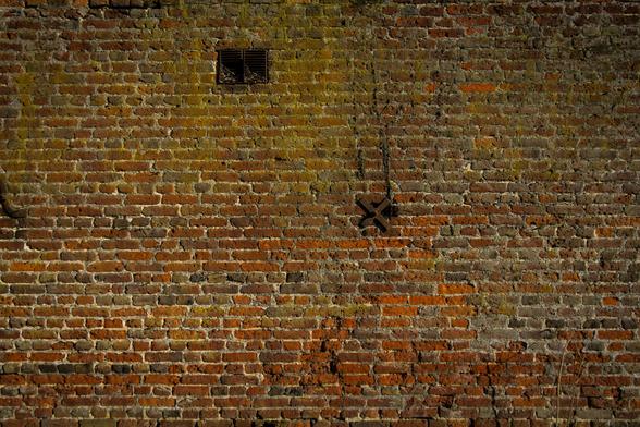 Detail of an old brick wall with metal braces.