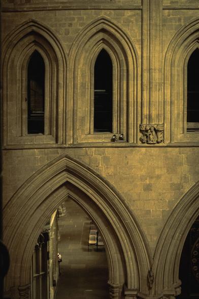 Detail of the cathedral interior, showing various arched windows and a passageway; through the bottom arch, you can see part of the nave at ground level.