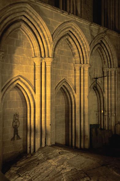 Inside of the main tower: a set of double blind arches with (on the left) graffiti of a badly drawn man.