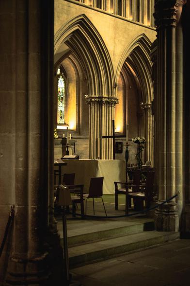 Interior of Wells Cathedral: looking at the back of the alter through the columns.