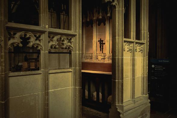Interior of Wells Cathedral: looking inside a side chapel where a small crucifix is seen.