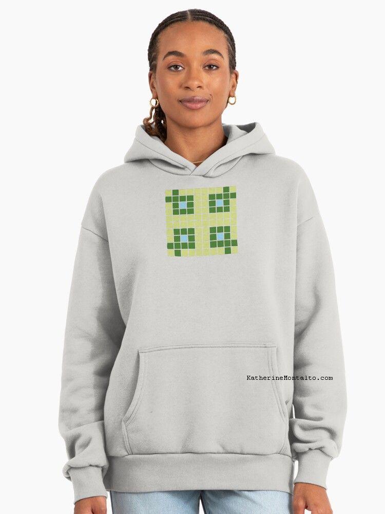 Abstract grid of multi-color squares printed on a pullover hoodie