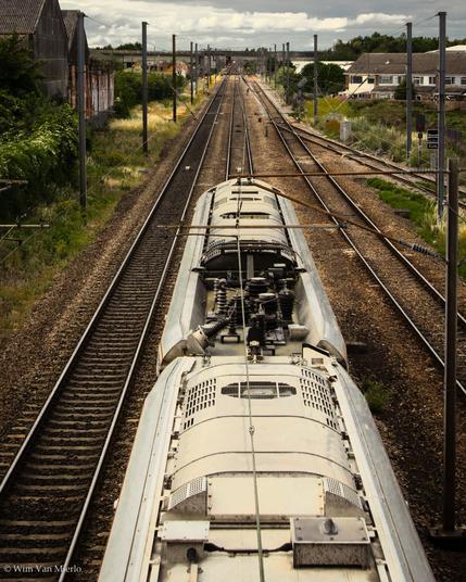 The roof of a modern train as it passes underneath the camera on the mainline.