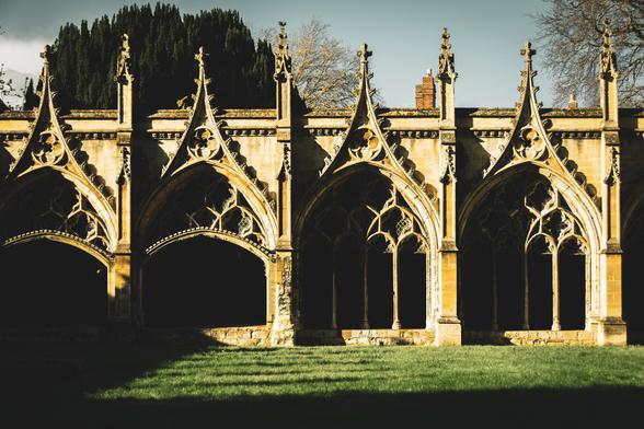 Gothic arches of the Cathedral cloisters in bright, afternoon sunlight