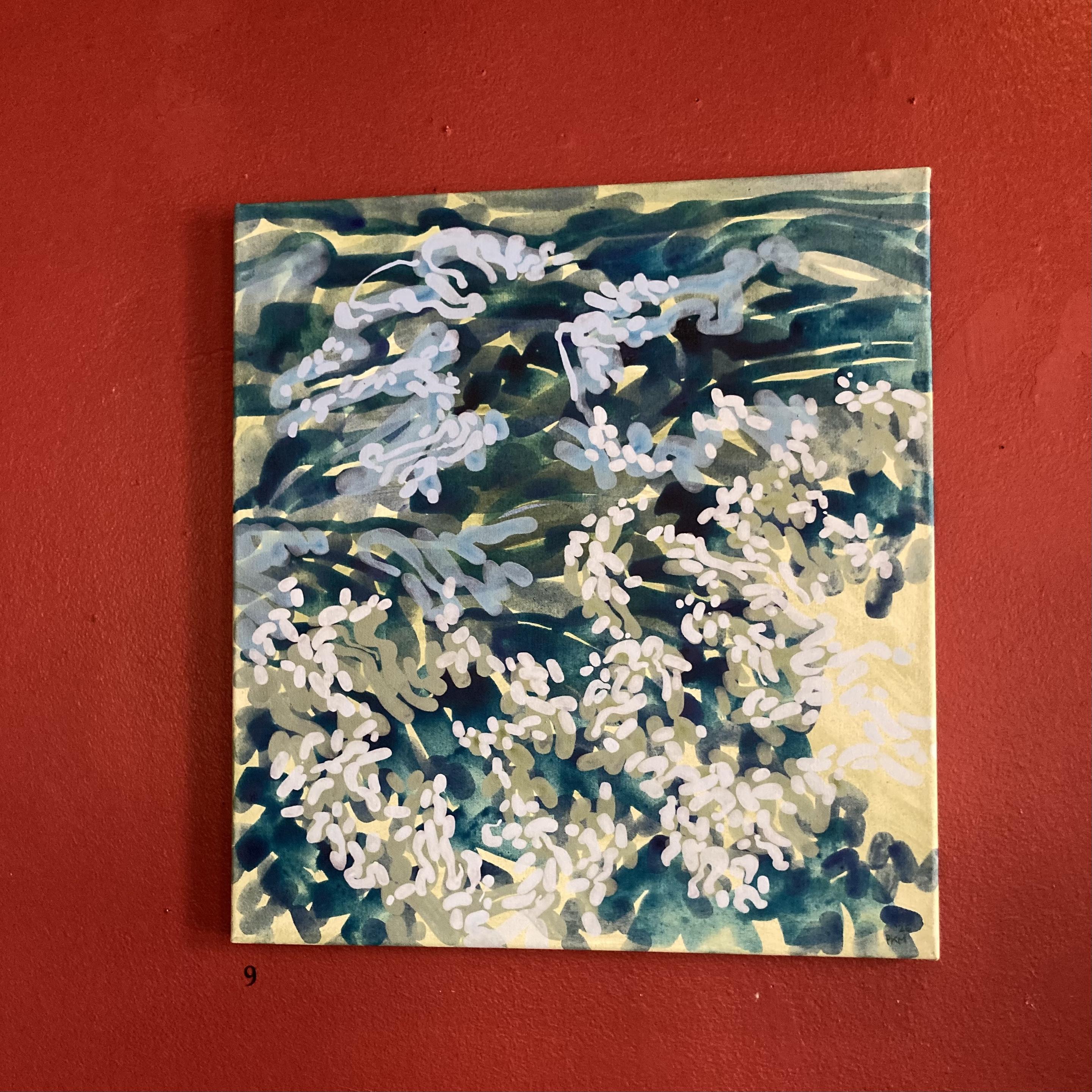 A close-up shot of an abstract painting depicting turbulent water in a surging river in shades of blue and green on a pale yellow background. The greens in the painting contrast starkly with the red wall the painting is hung on.