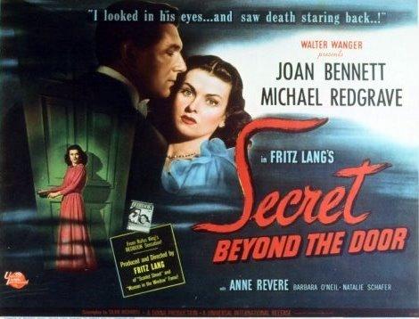 Main image, a man and woman embracing, the woman looking apprehensive. Other image, a woman with her hand on the handle of a large door in a dar setting. The whole poster has tendrils of mist floating across it. Text: "I looked in his eyes…and saw death staring back…!".

Poster for the 1947 movie "Secret Beyond the Door" starring Joan Bennett and Michael Redgrave.